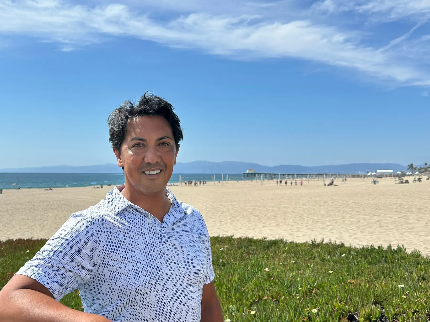 Joseph Ungoco standing near the Manhattan Beach shoreline